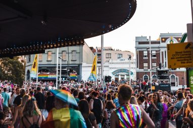 A lively and colorful LGBTQ+ parade on Sydney's Oxford Street with a festive crowd. — Coronavirus disease 2019