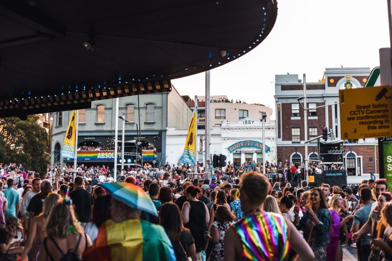 A lively and colorful LGBTQ+ parade on Sydney's Oxford Street with a festive crowd. — Coronavirus disease 2019